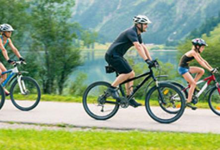 Photo: Family riding bikes along a paved path
