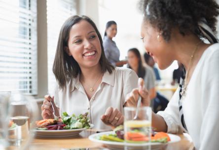 Women eating healthy and laughing