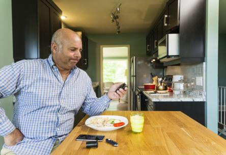 man stressed out looking at his blood sugar meter