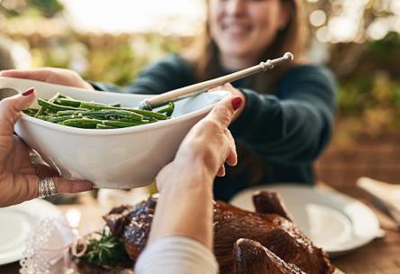 Family passing food at a family dinner.