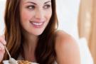 Photo: Smiling woman with bowl of cereal