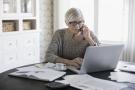 Woman sitting at computer talking to insurance customer service